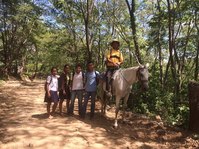 Teacher and pupils riding a horse in El Lagartillo, Nicaragua